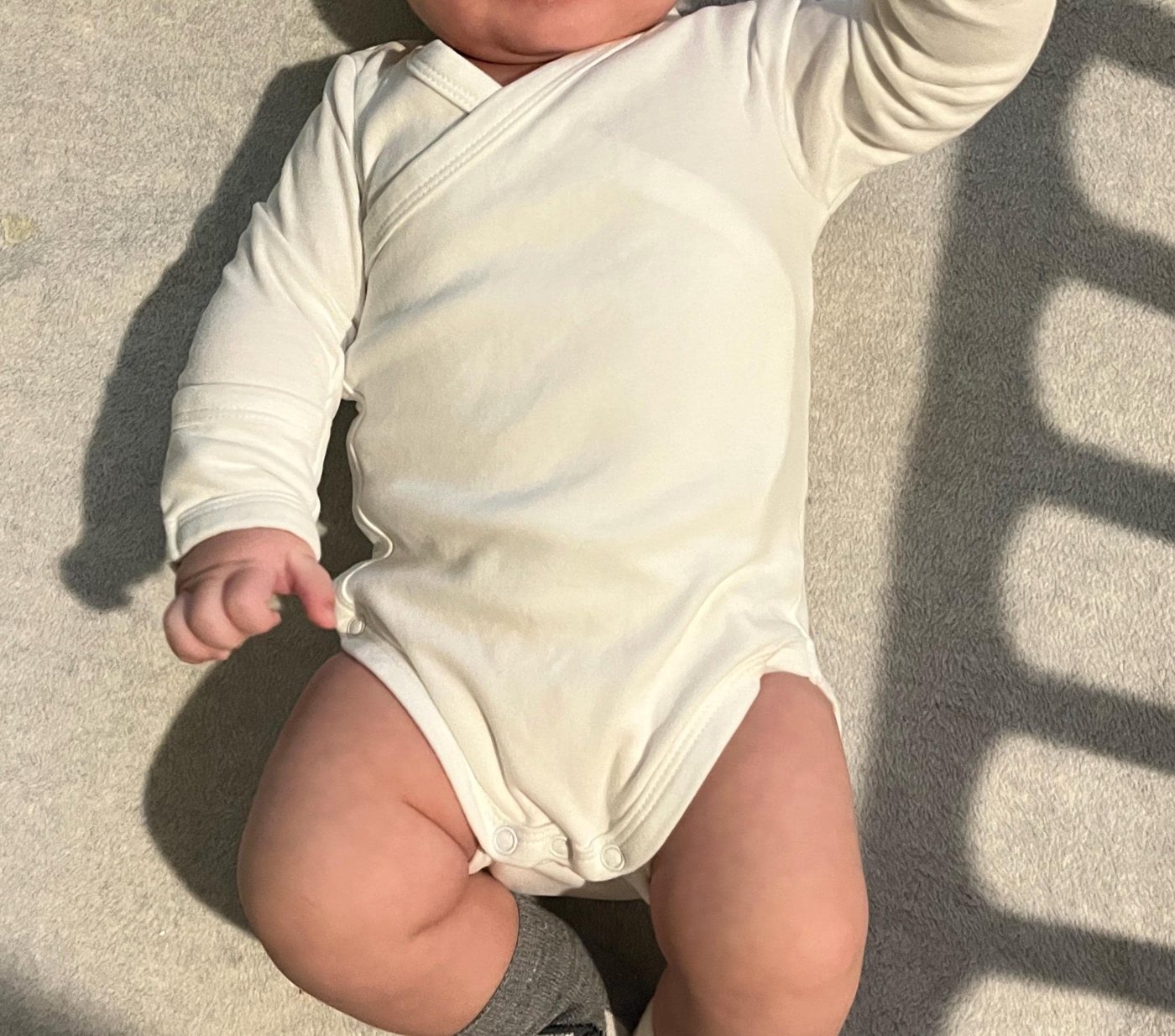 Baby wearing the white kimono romper